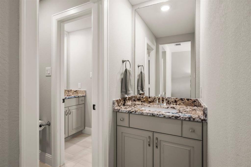 The Jack-and-Jill bath includes double sinks for ease of sharing.
