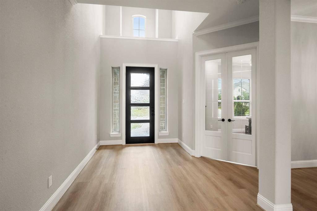 View from down the hall looking out to the front door entrance.