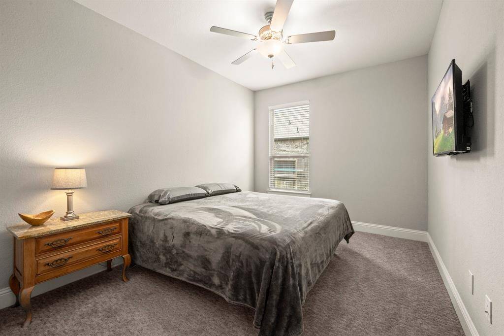 A private guest suite downstairs includes a spacious bedroom and a full bathroom nearby.