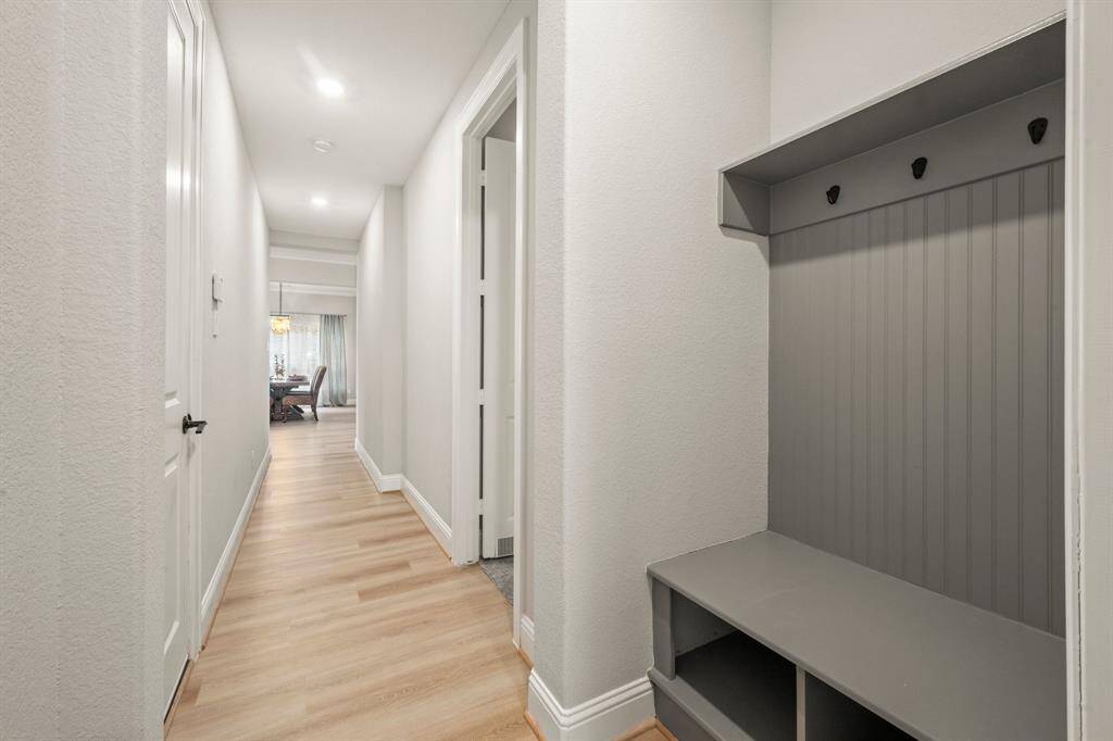A custom mudroom offers a drop zone for backpacks, shoes, and jackets. Located off the garage for maximum convenience.
