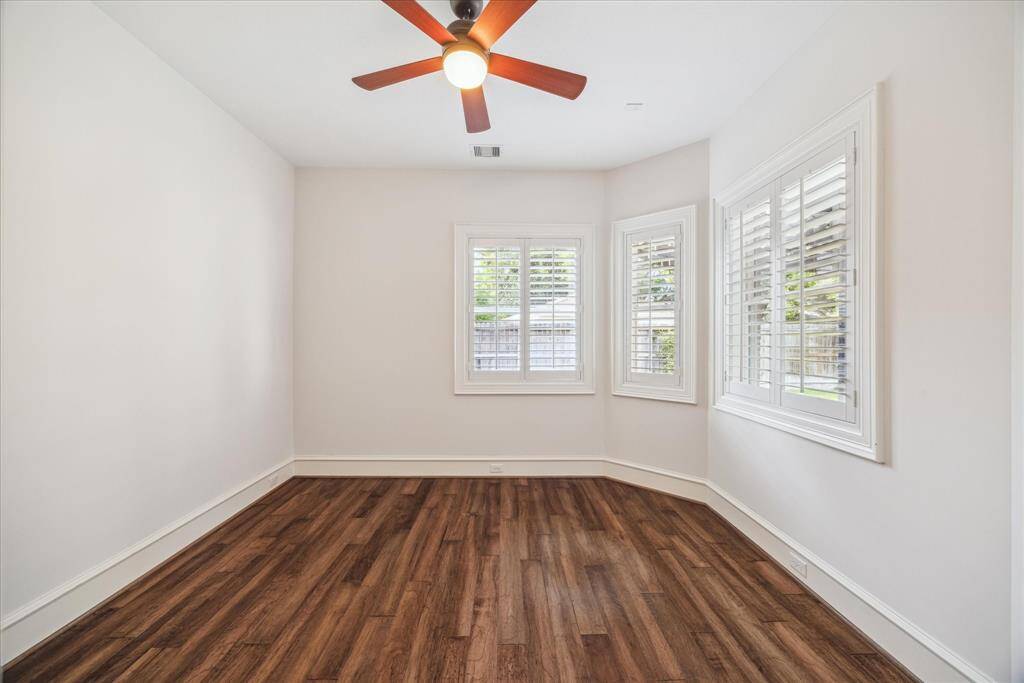 This spacious second bedroom downstairs offers comfort and versatility, perfect for guests or a home office. With plenty of natural light.