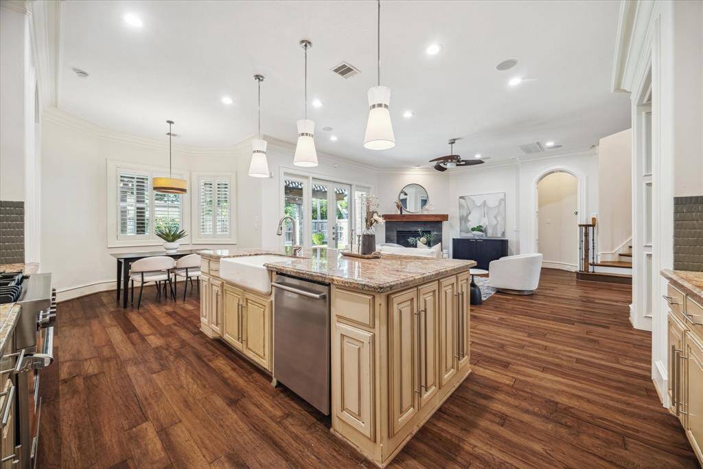 The open floor plan effortlessly connects the gourmet kitchen to the spacious family room, creating an inviting and functional space for entertaining and everyday living.