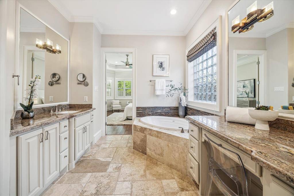 Custom cabinetry and a generous walk-in closet add both function and style, creating a serene oasis for relaxation and daily routines.
