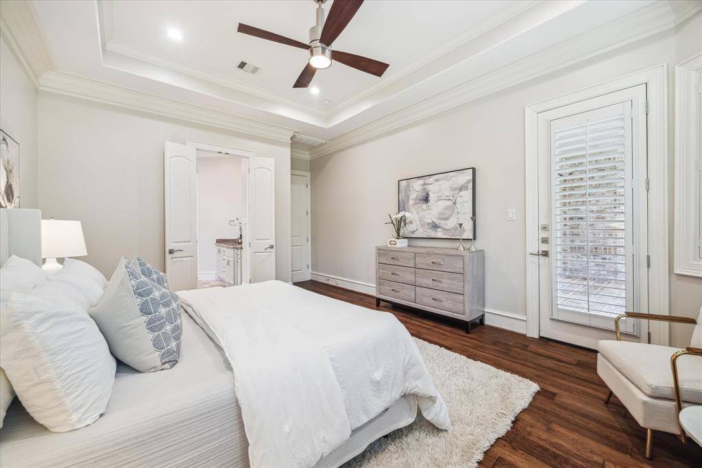 A cozy sitting area by the windows provides the perfect spot to relax, while direct access to the back patio offers seamless indoor-outdoor living.
