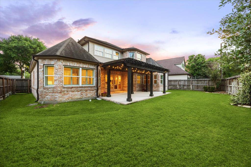 The backyard offers a private oasis perfect for outdoor living and entertaining. With a spacious patio area equipped with outdoor speakers and plenty of room for relaxation or play.