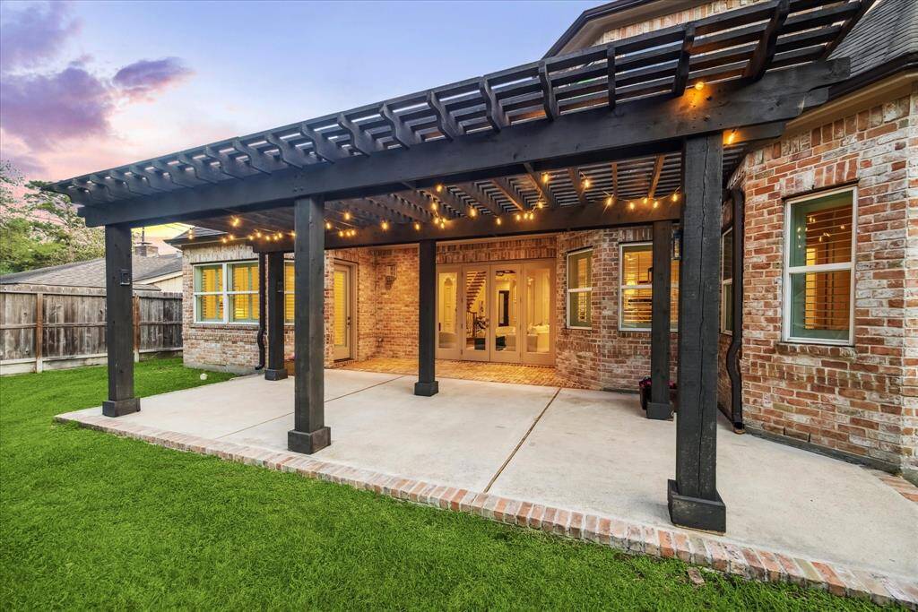 The back patio is a charming outdoor space featuring a beautiful pergola, perfect for relaxing or entertaining. With ample room for seating and enjoying the outdoors.