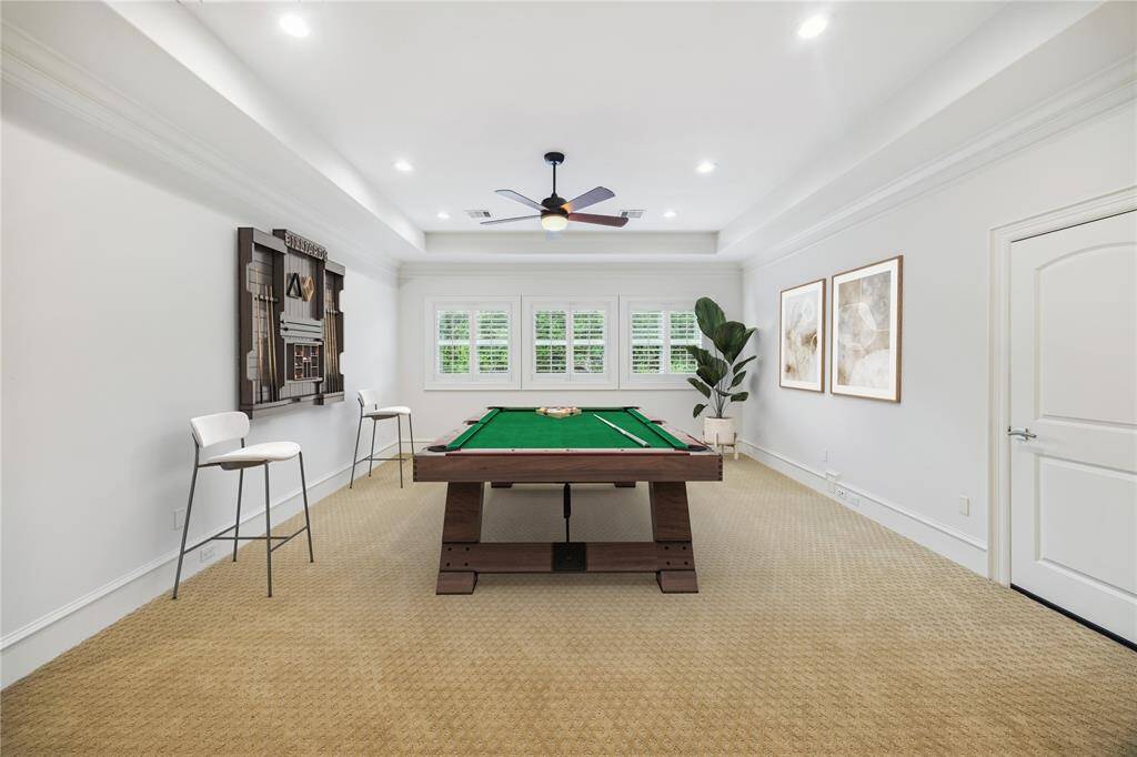 The spacious game room is perfect for family entertainment, featuring a tray ceiling that adds architectural elegance and a closet for convenient storage. *This versatile space has been virtually staged.