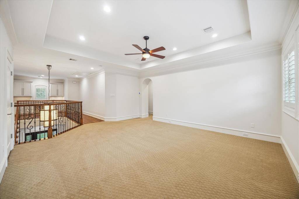 The spacious game room is complemented by two additional bedrooms upstairs, offering privacy and comfort for family members or guests.