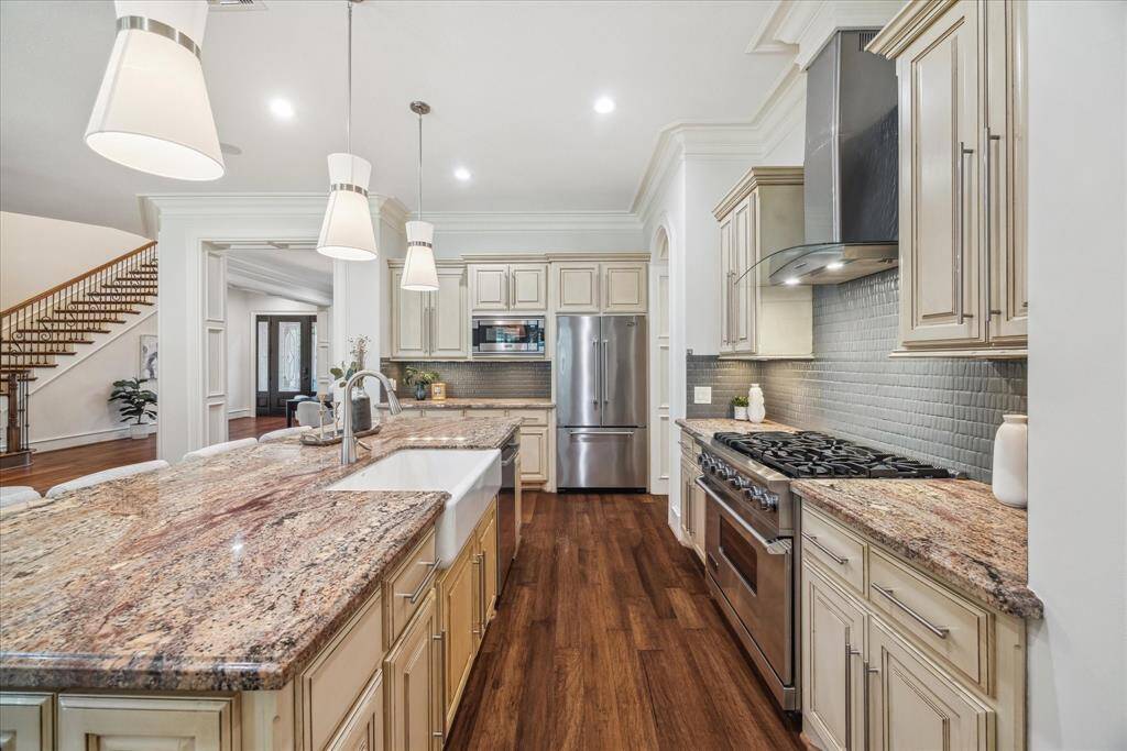 The farmhouse sink with an automatic faucet and walk-in pantry add function to the beautifully crafted design, all open to the family room for seamless entertaining.