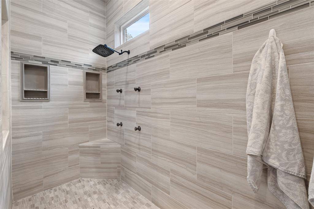 Talk about an at home spa day! Overhead rain shower and body spray nozzles will have you never wanting to leave this space.