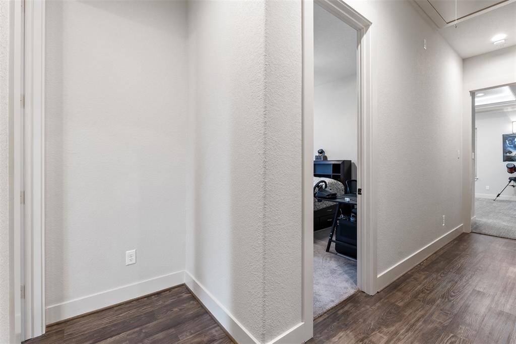 Let's hop over to the other side of the house. As you leave the living area, you enter the hallway that houses 2 bedrooms, a bathroom and the media room.