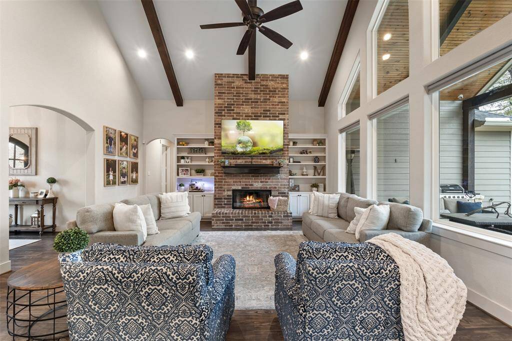 Floor to ceiling brick fire place with beautiful built-in storage.