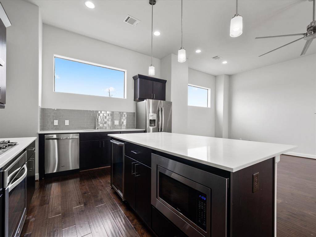 Modern appliances included—fridge, stove, dishwasher.