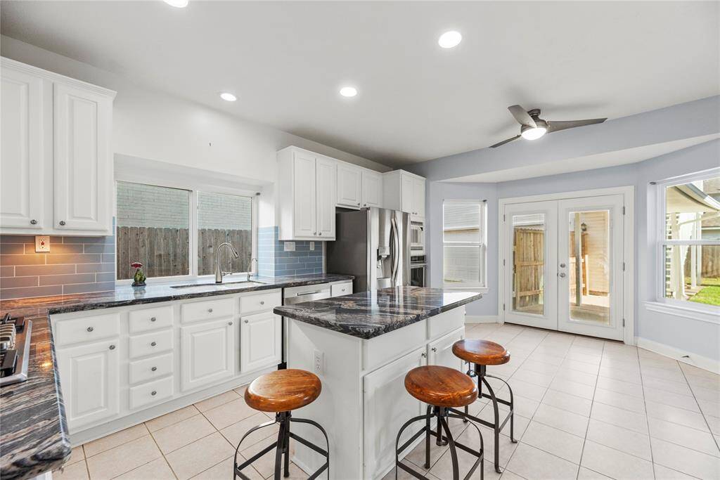 Tons of counter space and an island that is sure to be a natural space gathering space while the meals are made.  Open to the backyard makes the entertaining a breeze.