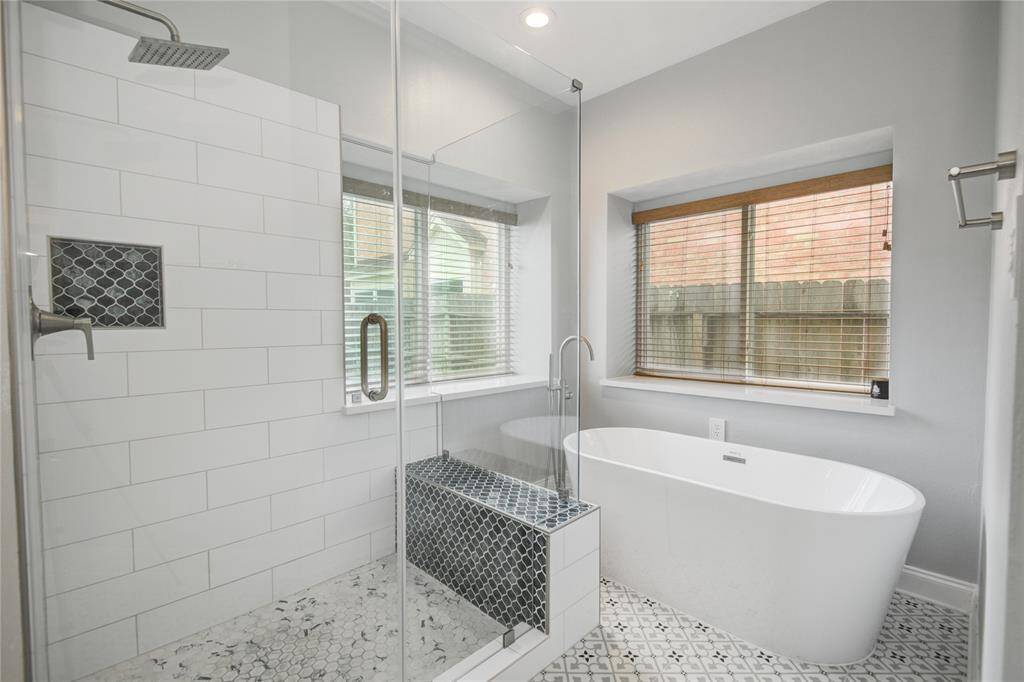 Unwind in your separate deep soaking tub or jump in the oversized glass shower for a quick rinse.  Notice all the designer tile work throughout the primary bath.