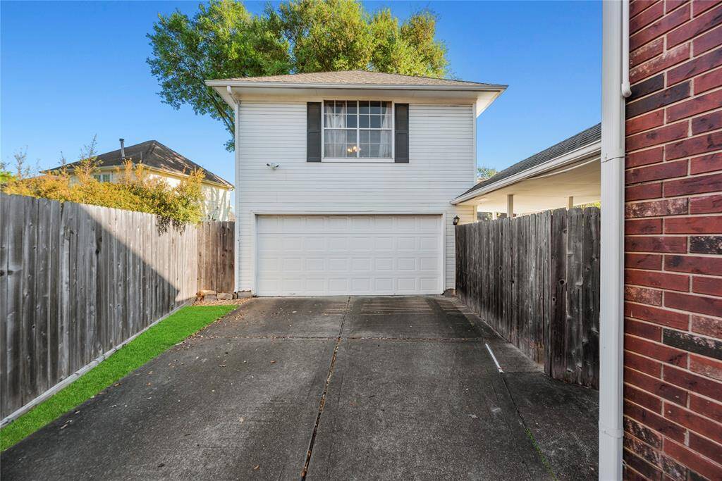 Long double wide driveway leading to your oversized garage with workspace above.
