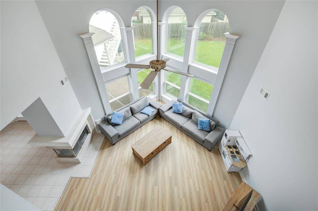 This living area is a large space with a comfortable and inviting feel with a wrap-around fireplace and open flow between the kitchen and living space. This is easy entertaining.