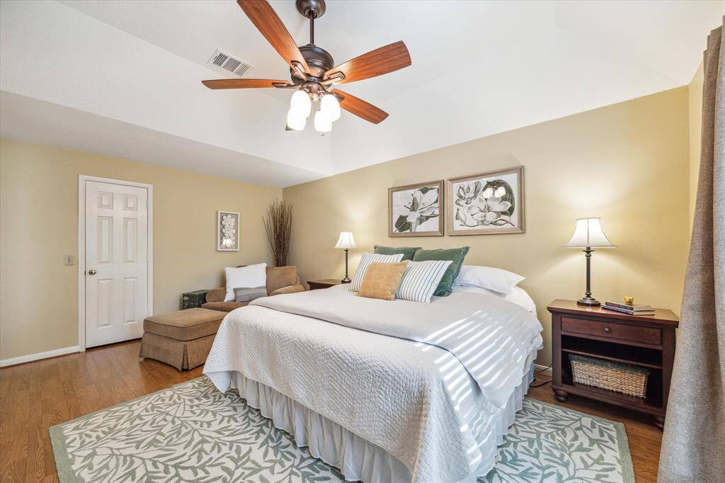 The spacious primary bedroom is located downstairs and privately tucked away at theback of the home. The door pictured is the large walk-in closet.