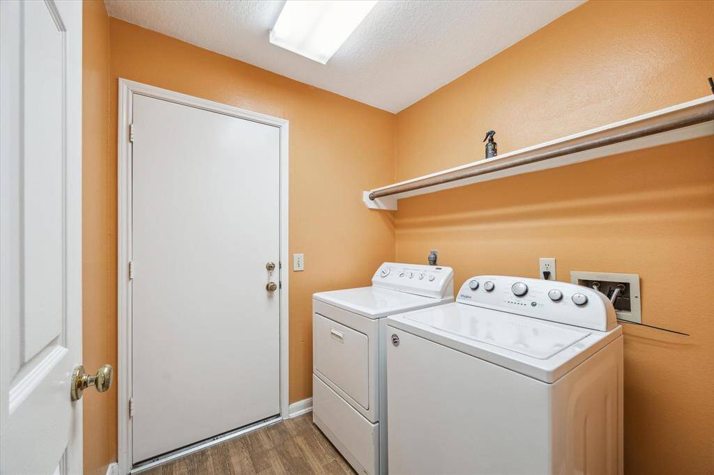 The laundry room is located downstairs. The door shown in the picture leads to the 2 car garage. There is also a large storage closet not pictured here.