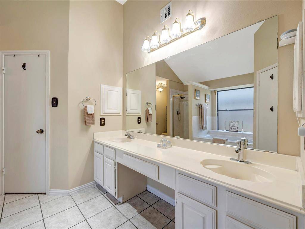 Primary Bathroom with double sinks and two walk in closets