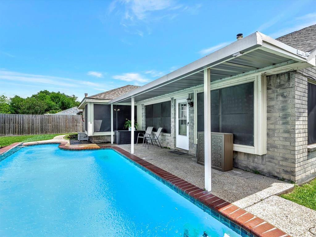 Covered patio perfect for entertaining by the pool.