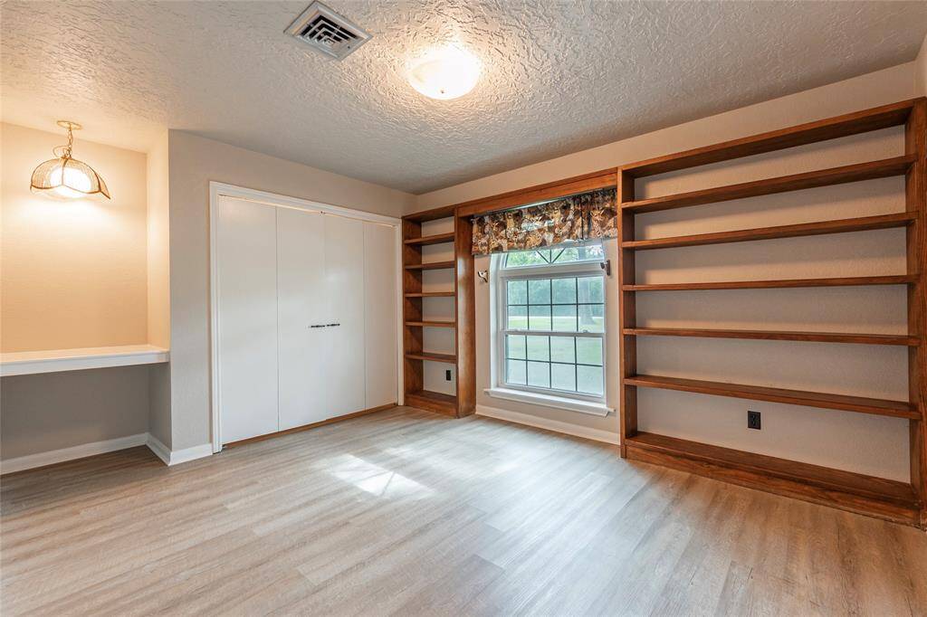 guest room at the front of the home with built in shelves