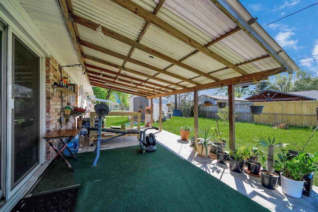 Walk outside through the new storm doors and enjoy the nice shade provided by the covered paved patio space.