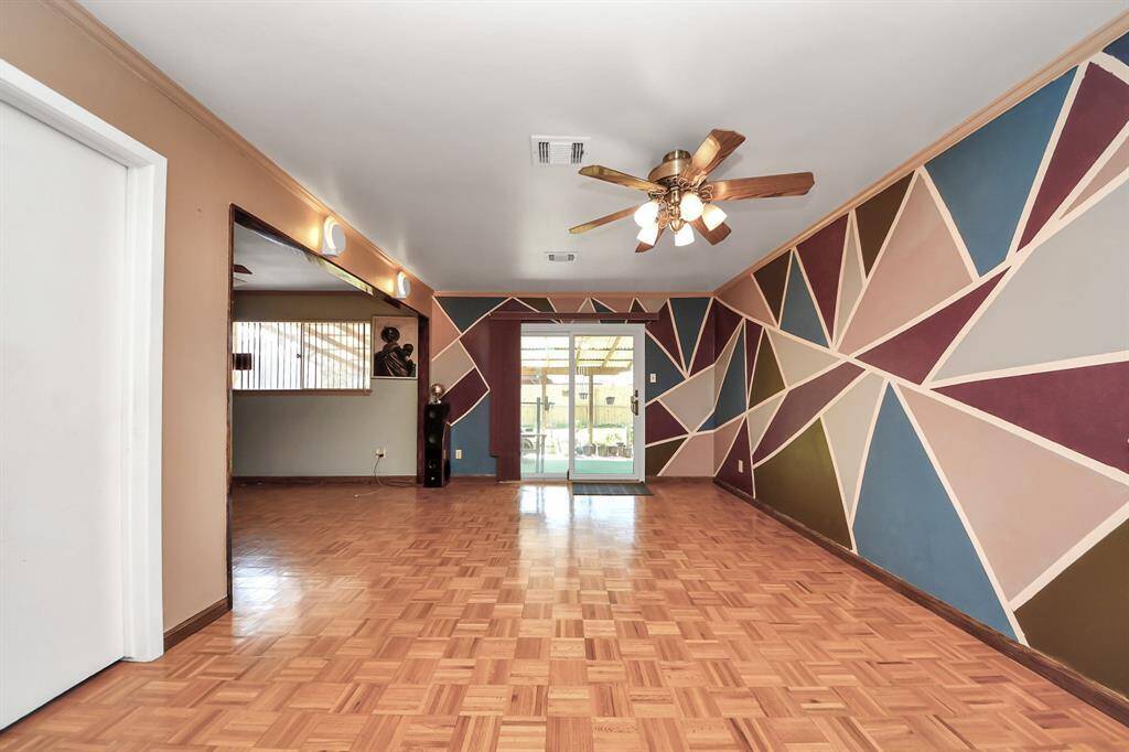 Living space lead to adjoining rooms, enhancing the open layout with access to the back patio.