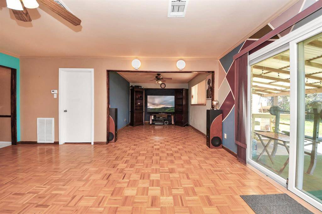 Spacious living room features glass patio doors, and a bright and airy atmosphere.