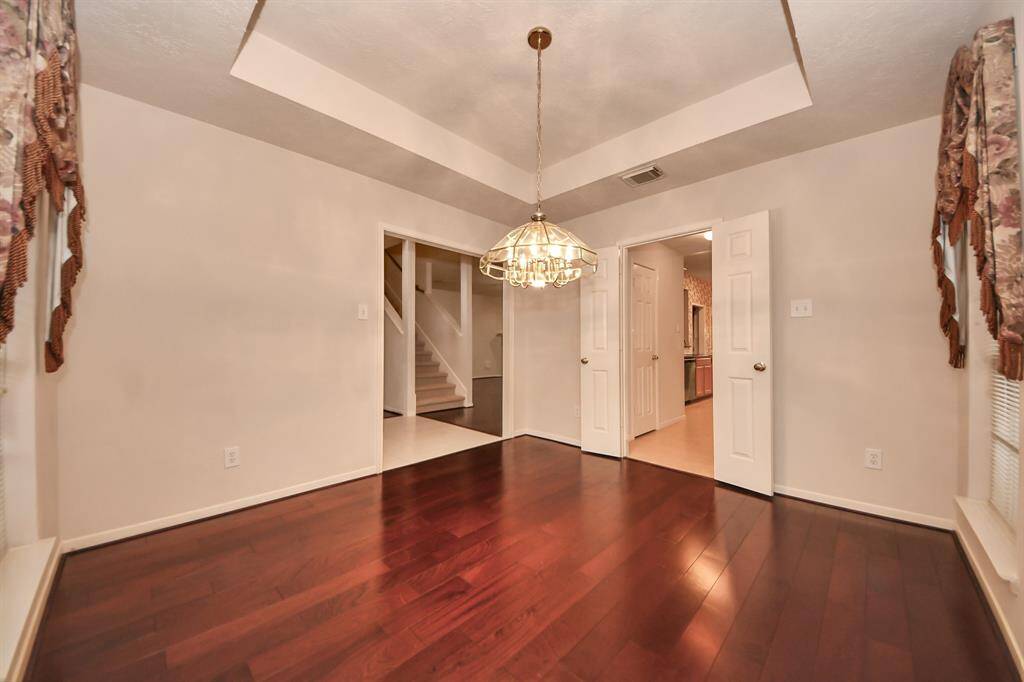 Dining room has open doorways leading to kitchen.