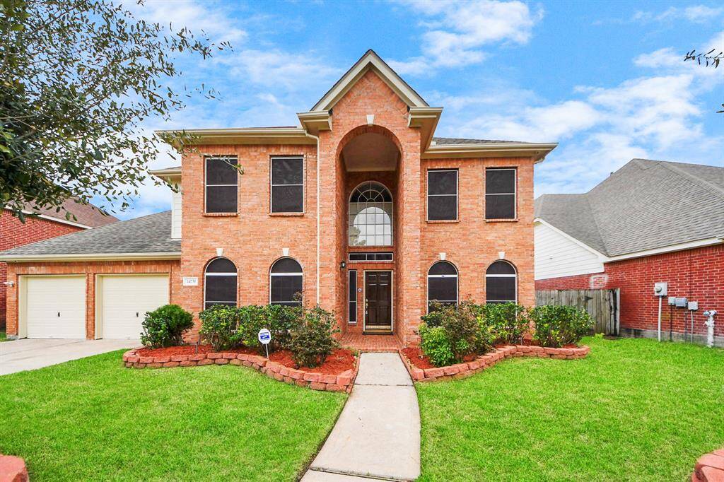Well-maintained landscaping, and a spacious front yard.
