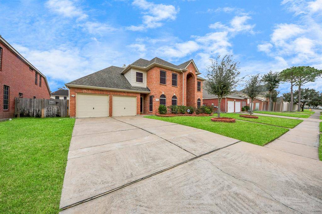 Two-car garage and separate entrance at the side.