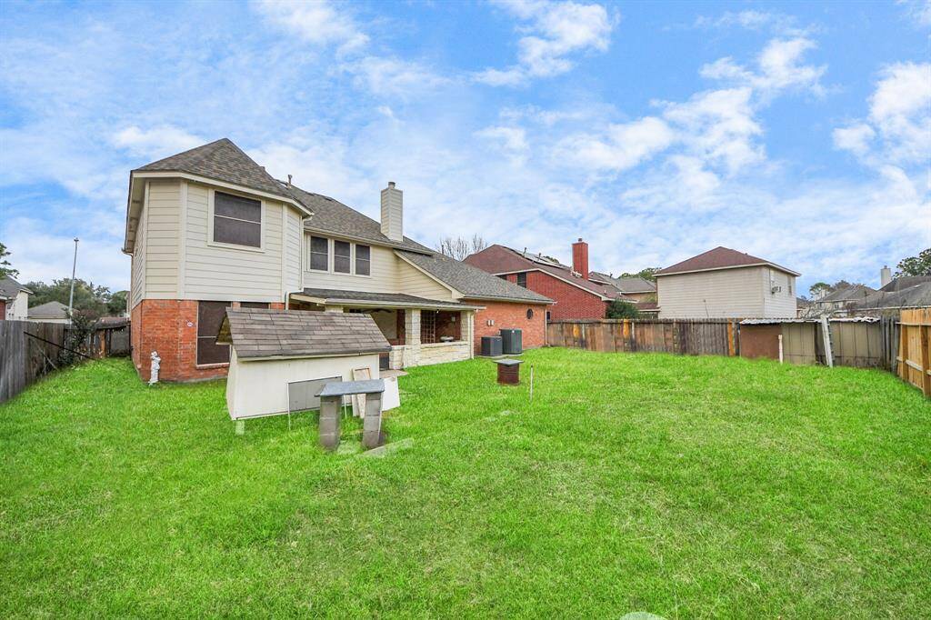 Spacious backyard with lush green lawn.