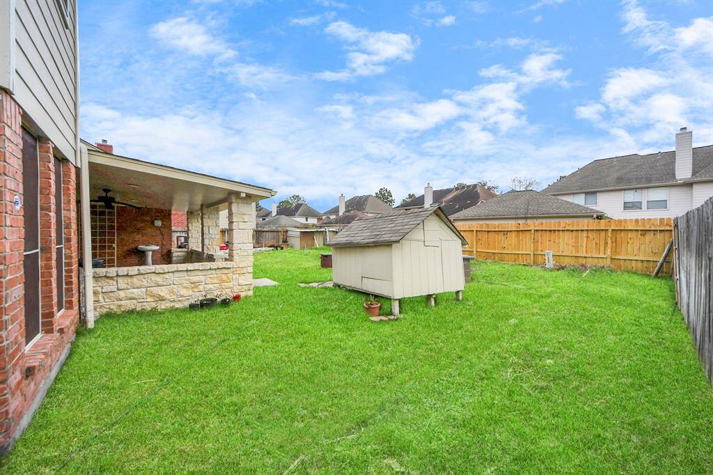 This backyard features a well-maintained lawn, ideal for outdoor activities and gatherings.