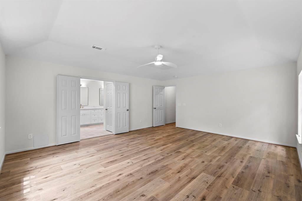 This bedroom also features a vaulted ceiling.