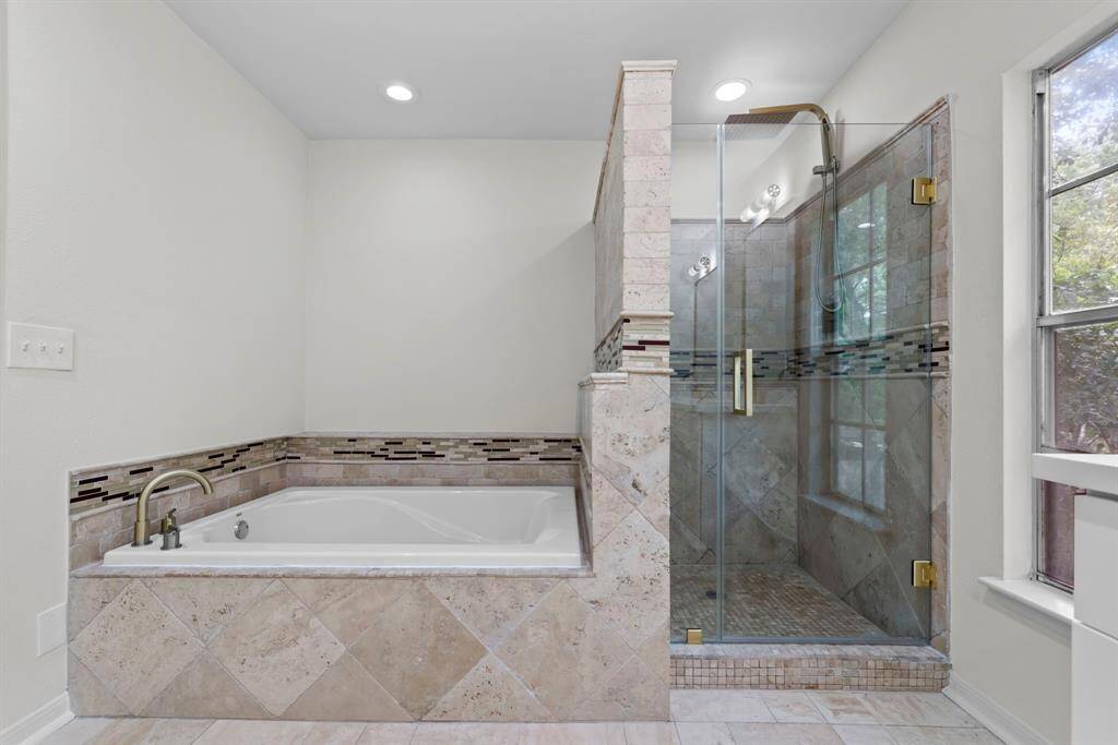 Primary bathroom has also been recently updated to reflect the newest trends in bathroom design. Not pictured, is a double vanity with soft-close cabinets and drawers.