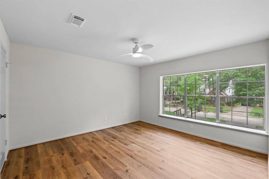 Generously sized third bedroom, measuring 12'X13'; with an abundance of natural light from three windows that offer a charming view of the front yard.
