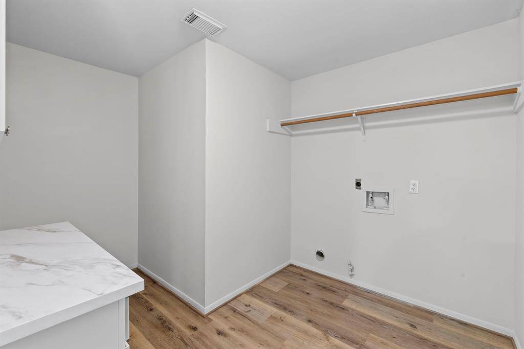 Enjoy the convenience of a laundry room that offers extra storage, countertop space, and a space dedicated for an additional refridgerator!