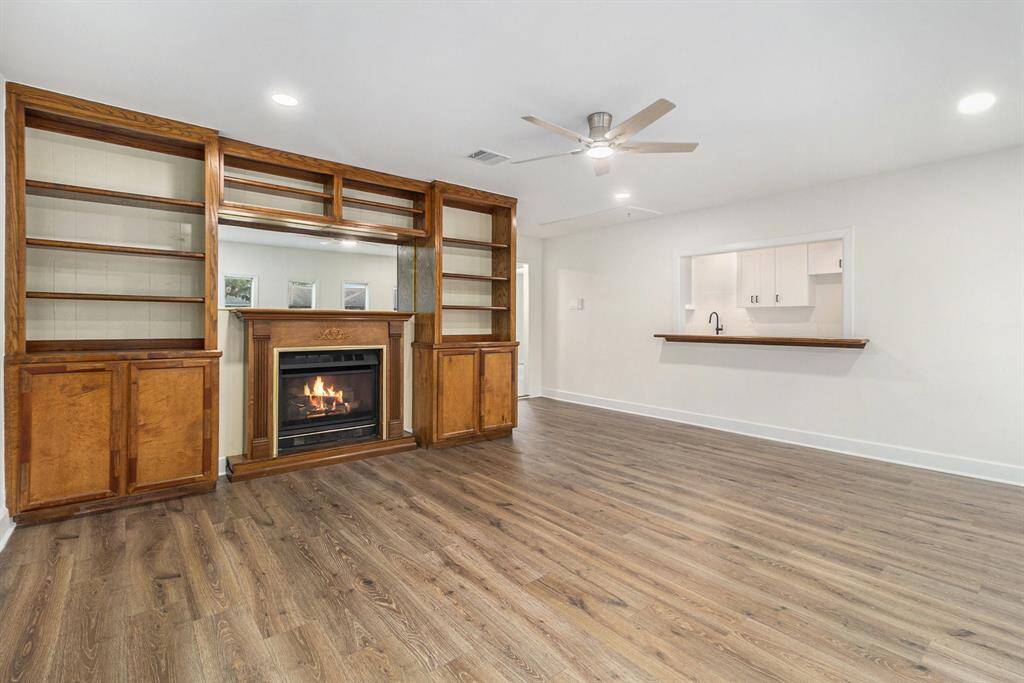 Custom built wood shelves with gas fireplace.