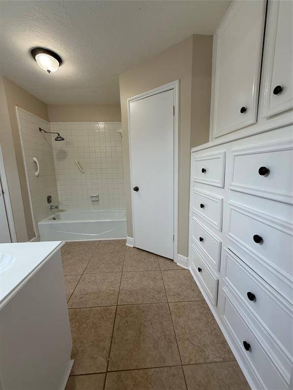 The main bathroom. It has two closets and built in cabinets.