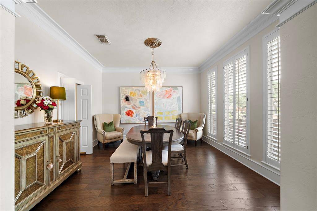 Formal dining room- flooring replaced and lighting. Fresh interior paint.  Custom shutters throughout!