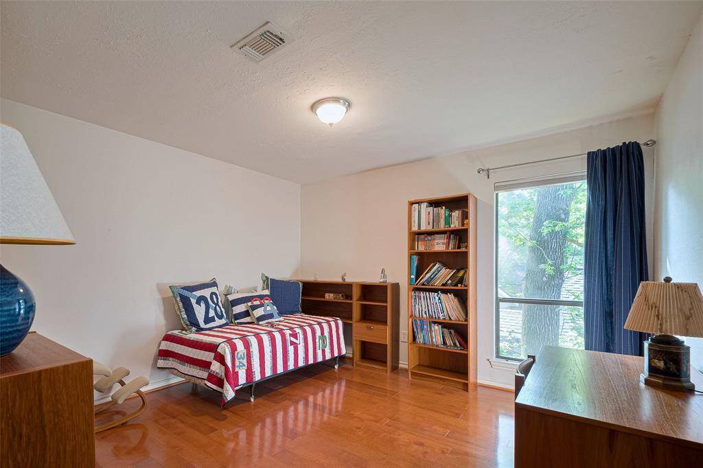 The fourth bedroom on the second level features high ceilings, a soothing neutral palette, and lovely views of thebackyard. It also includes its own closet and convenient access to a shared bath across the hall, combining comfort with practicality.