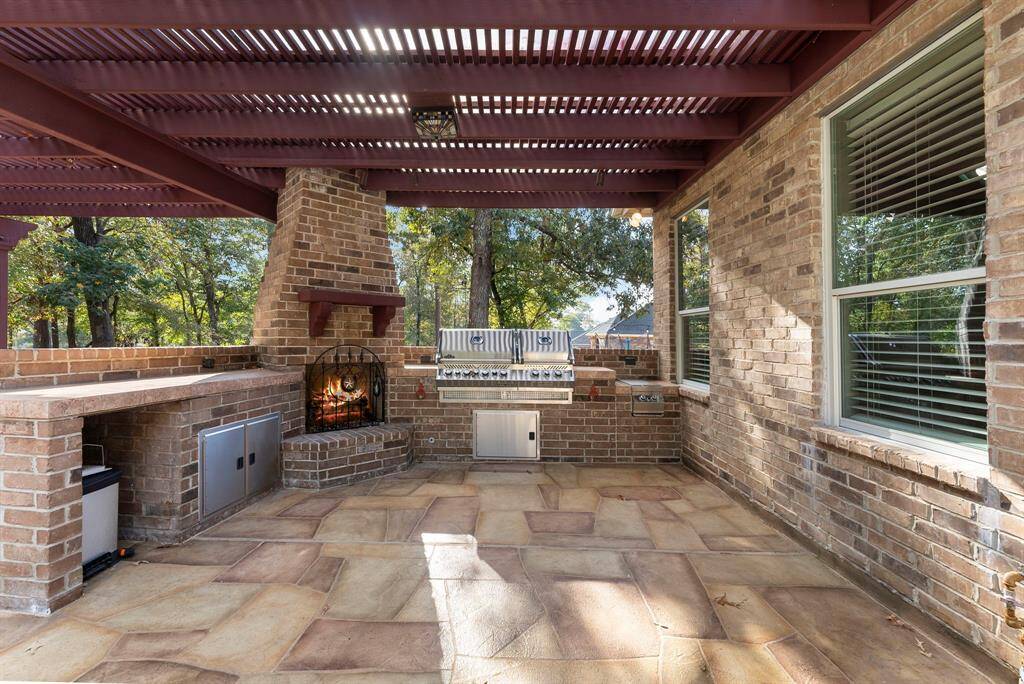Outside is also complete with a full outdoor kitchen and fireplace.