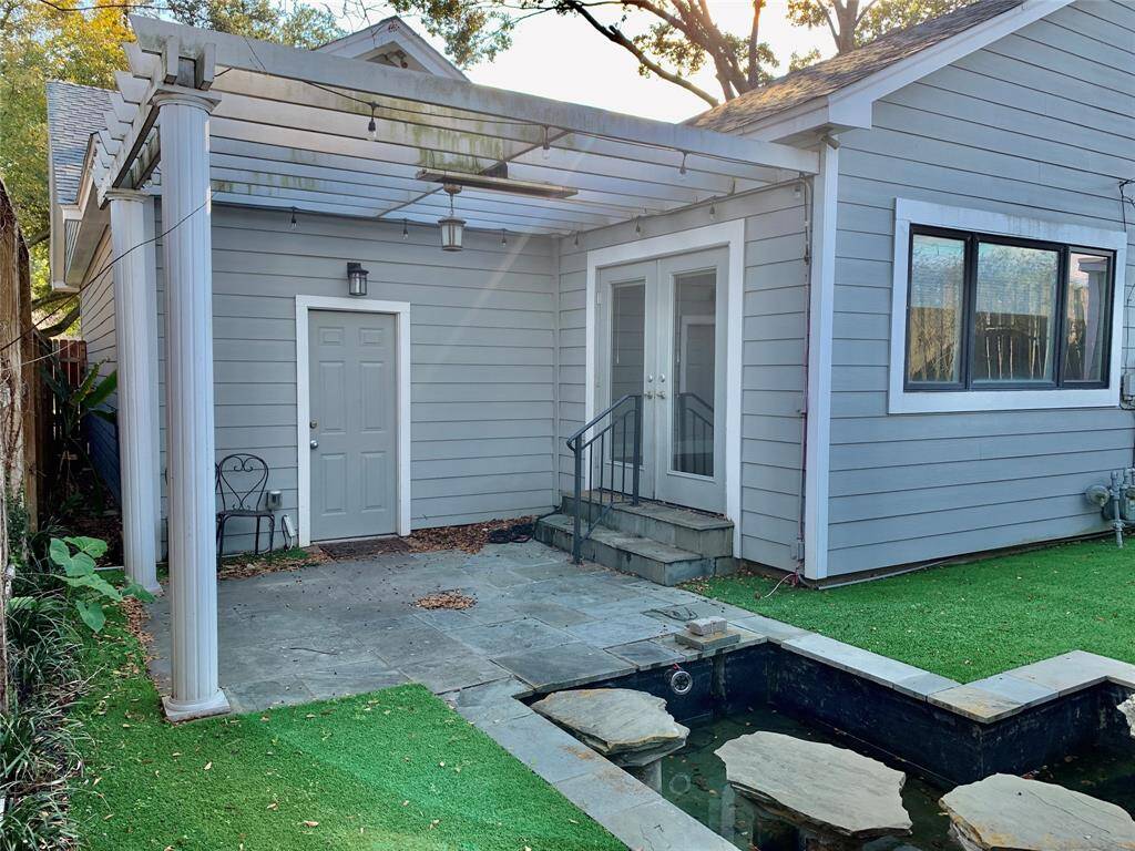 Backyard oasis with pergola, pond and turf for low maintenance