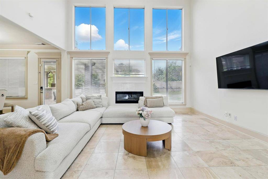 The  family living room benefits from abundant natural light streaming in through large windows that likely offer a pleasant view