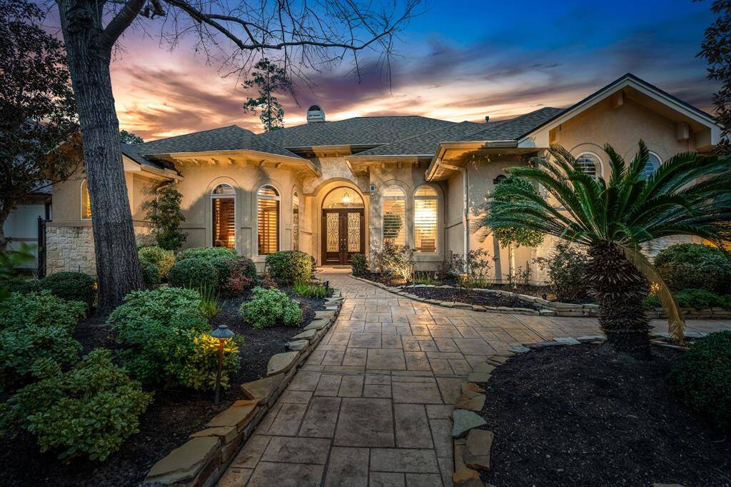Welcome to 16618 Victoria Falls Drive! This exquisite home, located inside the private gated community, The Falls at Champion Forest, features a beautifully landscaped front yard with a stone pathway leading to an inviting entrance. The elegant exterior, enhanced by stone accents & warm lighting, offers a welcoming ambiance, perfect for evening relaxation.