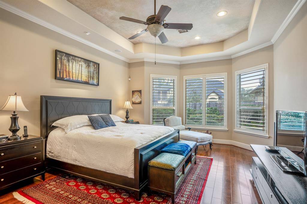 The owner's suite exudes luxury with its expansive bay windows overlooking the backyard and pool, allowing abundant natural light to fill the space and offering a cozy nook for relaxation. The room's design emphasizes comfort and elegance, seamlessly connecting to a spacious ensuite bathroom. Enjoy your privacy, being the only bedroom on this side of the home, away from the others.