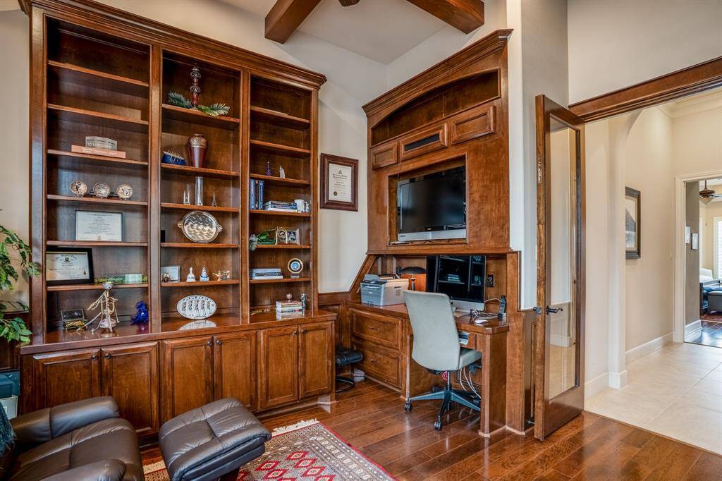 Alternate angle of the handsome office showing the built-in desk and glass double doors.