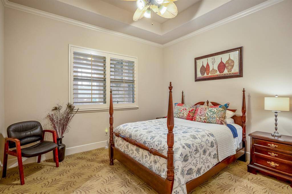 This spacious first-floor bedroom offers comfort and privacy, featuring large windows that allow natural light to fill the room. The neutral color palette and plush designer carpeting create a warm and inviting atmosphere.