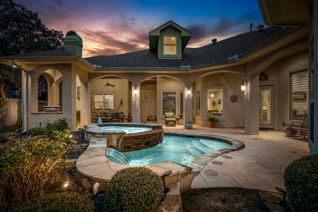 The star of the show - The backyard presents a tranquil oasis, featuring a shimmering pool encircled by natural stone and enhanced by cascading waterfalls. An integrated hot tub provides a serene spot for relaxation, seamlessly blending into the landscape.